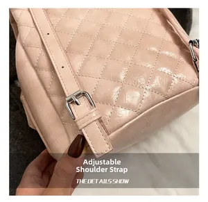 Detail of adjustable pink quilted shoulder strap with silver buckle on women backpack