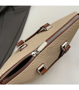 Detailed macro shot of smooth silver zipper and woven texture on the beige bucket bag