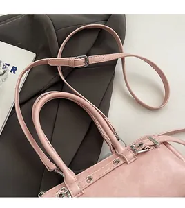 Detailed macro view of the pink Boston bag handles and silver metal hardware accents