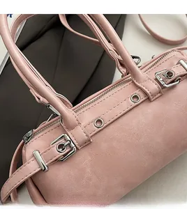 Detailed macro view of the premium silver hardware and textured pink Boston bag material