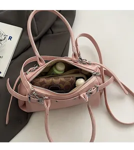 Internal view of pink Boston handbag showing spacious capacity for wallet and skincare