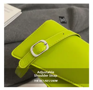 Detail view of the bright green leather baguette bag with adjustable silver buckle strap