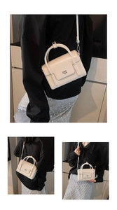 Lifestyle views of a white oil wax leather square handbag worn crossbody and handheld