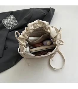 Detail showing the spacious interior of this beige cloud bag with a zipper pocket