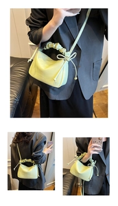 Detail of lime green crescent bag showing ruched handle and ribbon bow tie textures