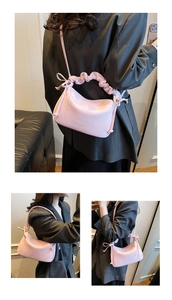 Detail showing pink faux leather texture and ruffled scrunchie handle of the shoulder bag