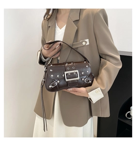 Close-up of dark brown leather handbag featuring silver studs and a retro Y2K buckle detail