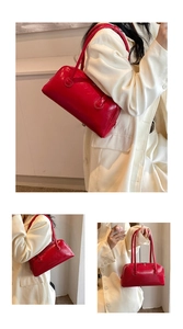 Close-up of bright red patent leather shoulder bag with smooth glossy finish and stitching