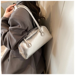 Detail of silver metallic Boston bag with vintage cracked texture and top zipper closure