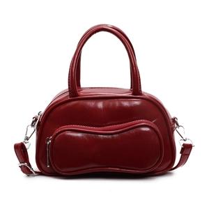 Glossy burgundy leather bowling bag with vintage handles and removable strap
