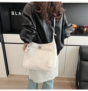 Detailed back view of a white leather bucket bag with decorative strap and metal clasp