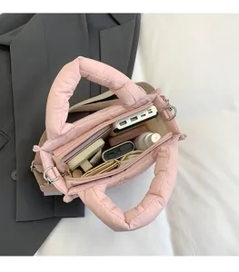 Innenansicht mit großem Stauraum und Fächern der rosafarbenen gesteppten Tasche