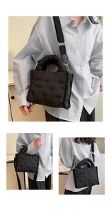 Detail der schwarzen gesteppten Daunentasche mit verstellbarem Nylon-Schultergurt