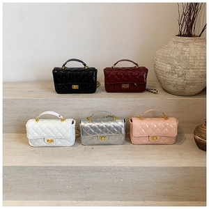 Collection of quilted patent leather crossbody bags in five elegant colors on display