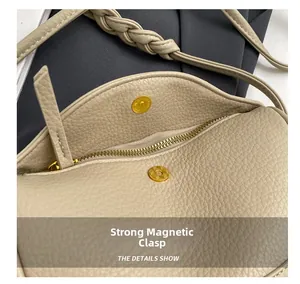 Detail of beige lychee leather bag with magnetic snap closure and gold zipper