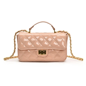 Glossy nude pink quilted chain bag with gold metal handle and turn-lock closure