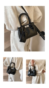 Detail of black patent leather Kelly bag with silver lock and mini card pouch accessory