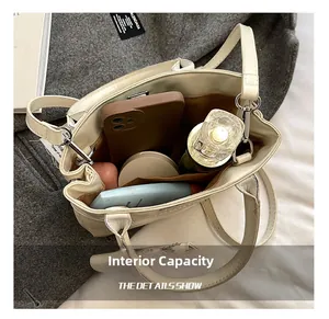 Top view showing the spacious interior compartment of the cream leather shoulder bag