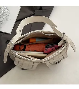 Detailed top view of the spacious inner compartment of the ivory biker style shoulder bag
