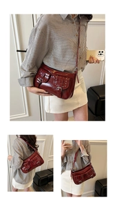 Detail view of burgundy leather underarm bag with silver rivets and pockets