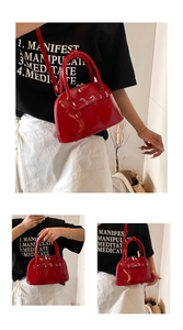 Detail showing red glossy shell bag with silver metal ring buckle and dual handles