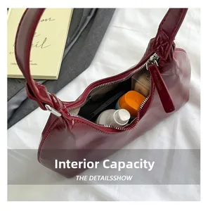 Detailed interior of vintage burgundy faux leather bag showing daily storage capacity
