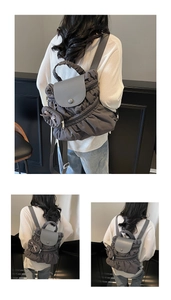 Detail of grey pleated backpack featuring a leather flap and ruffle handle design