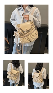 Detail of beige pleated nylon backpack with matching mini pouch and top handle