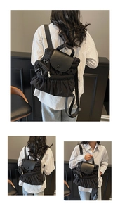 Detail of black pleated nylon backpack with leather flap and detachable small coin purse