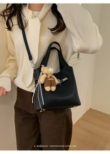Chic black lychee grain bucket bag with cute bear charm and silver hardware shown on model