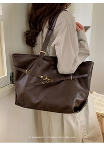 Detail of vintage coffee tote bag with adjustable straps and retro gold buckle