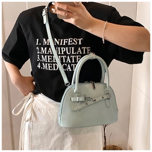 Detail of light blue shell crossbody bag with silver hardware and adjustable strap