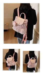 Detail showing the pink pleated fabric texture and faux leather flap of the backpack