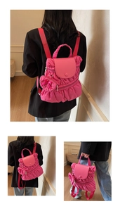 Detailed views of a pink pleated backpack with heart-shaped charm and red shoulder straps