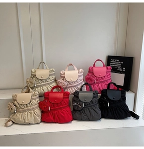 Detail view of colorful pleated nylon backpacks with matching heart-shaped mini pouches