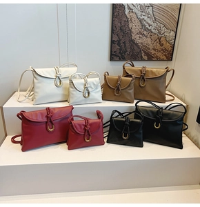 Comparison of classic shoulder bags in various colors and sizes with knot detail