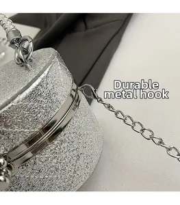 Detail of durable silver lobster clasp and sparkling quilted glitter finish on a mini bag