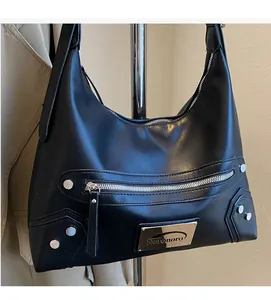 Detail showing soft black faux leather texture and silver studs on the motorcycle shoulder bag