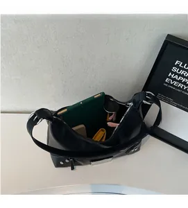 Top view of large black leather shoulder bag showing spacious interior with tablet and makeup
