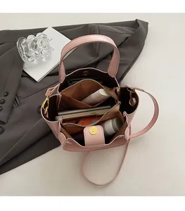Top view of pink bucket bag interior showing spacious capacity with items and gold hardware