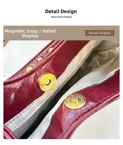 Macro shot of magnetic snap closure on burgundy pleated leather bag with chevron lining