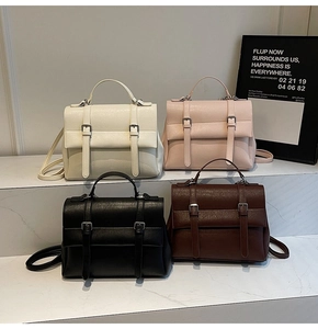 Group display of vintage satchels in beige, pink, black and brown leather textures