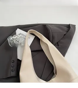 Detail of beige lychee grain leather tote bag showing comfortable strap and stitching