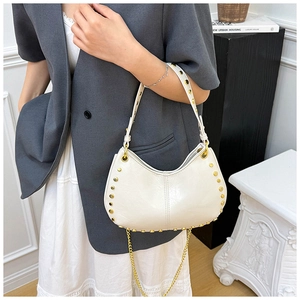 White leather shoulder bag featuring gold stud rivets and a thin chain detail