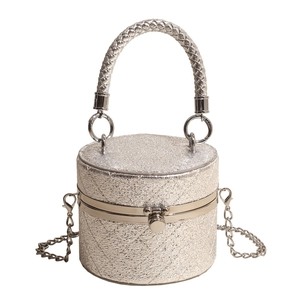 Silver glitter cylindrical mini crossbody bag with quilted texture and woven handle