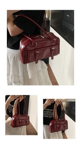 Wine red oil wax leather shoulder bag featuring stylish double front pockets and retro pillow design.