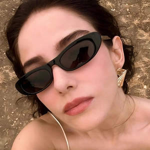 Fashionable oversized cat-eye sunglasses with golden fan-shaped metal earrings for women
