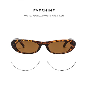 Close-up of retro oval sunglasses with tortoiseshell frame and tinted amber lenses