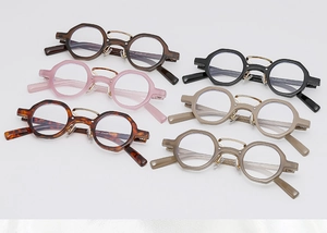 Flat lay of retro round sunglasses in multiple colors showing frames and metal nose pads