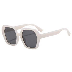 Stylish cream hexagonal sunglasses with dark grey lenses shown from a 45-degree angle